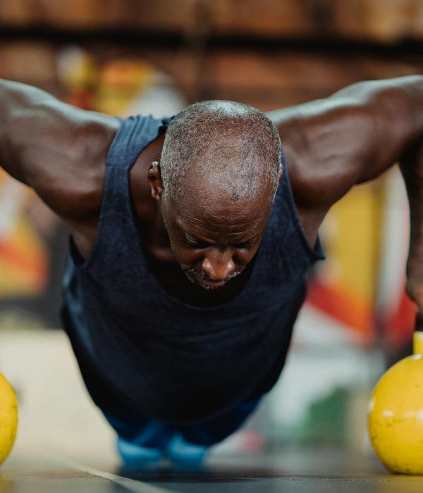 Focused man holding a kettlebell during a workout.